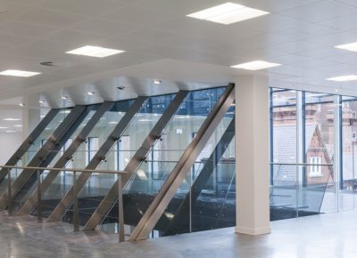 View from the top floor of a modern office building towards lift assembly